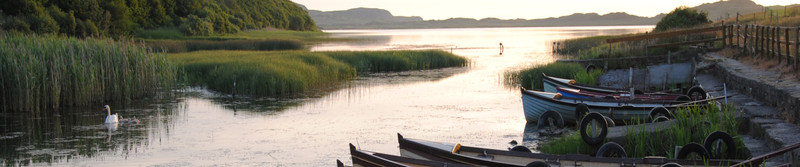 Rowing boats moored at the side of the new lake on a warm summer's evening