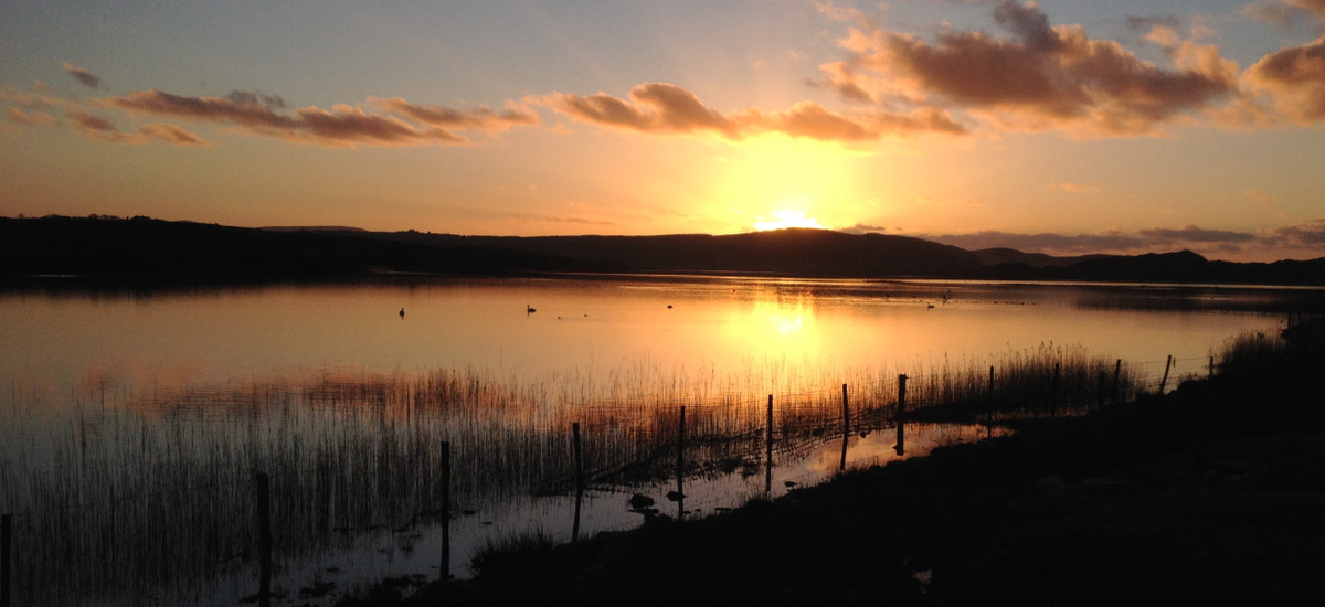 The sun setting over new lake